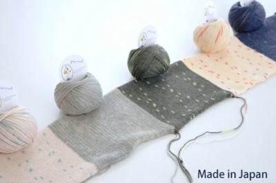 A knitted swatch in Pierrot Star Pochette, demonstrating the crisp stitch definition and the natural elasticity of the cotton-wool blend