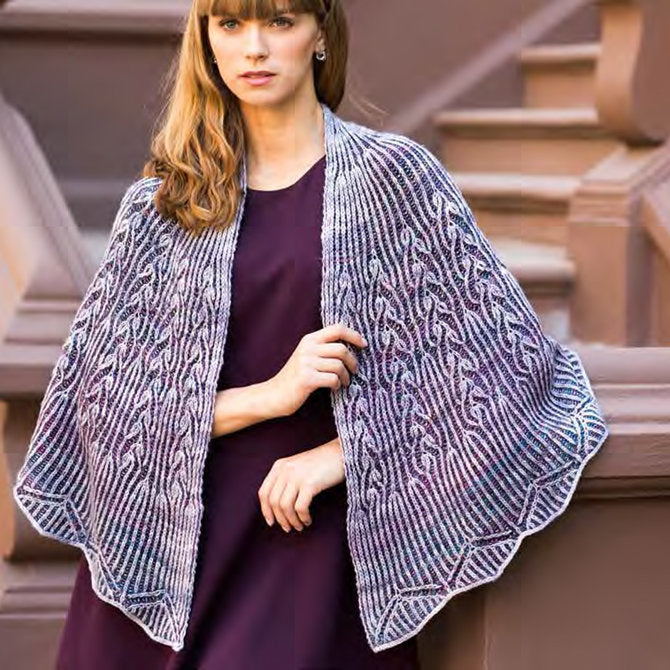 lose-up of a lace shawl from the Shawl Road collection, highlighting the incredible stitch definition and 'watercolor' dye effects.